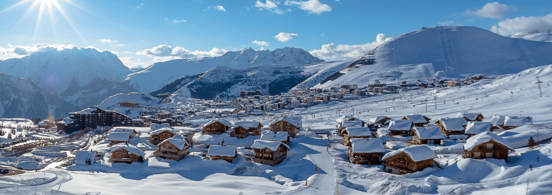 A snowy ski resort with green and blue runs