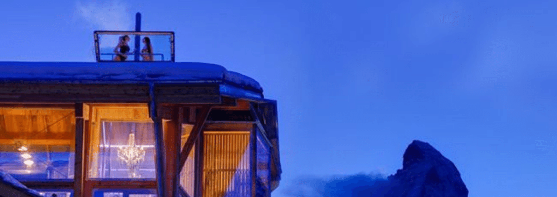 Two friends in a rooftop hot tub in a private ski chalet